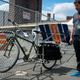 Illustration for article titled This Apocalypse-Ready Solar Charging Station Folds Up Behind a Bike